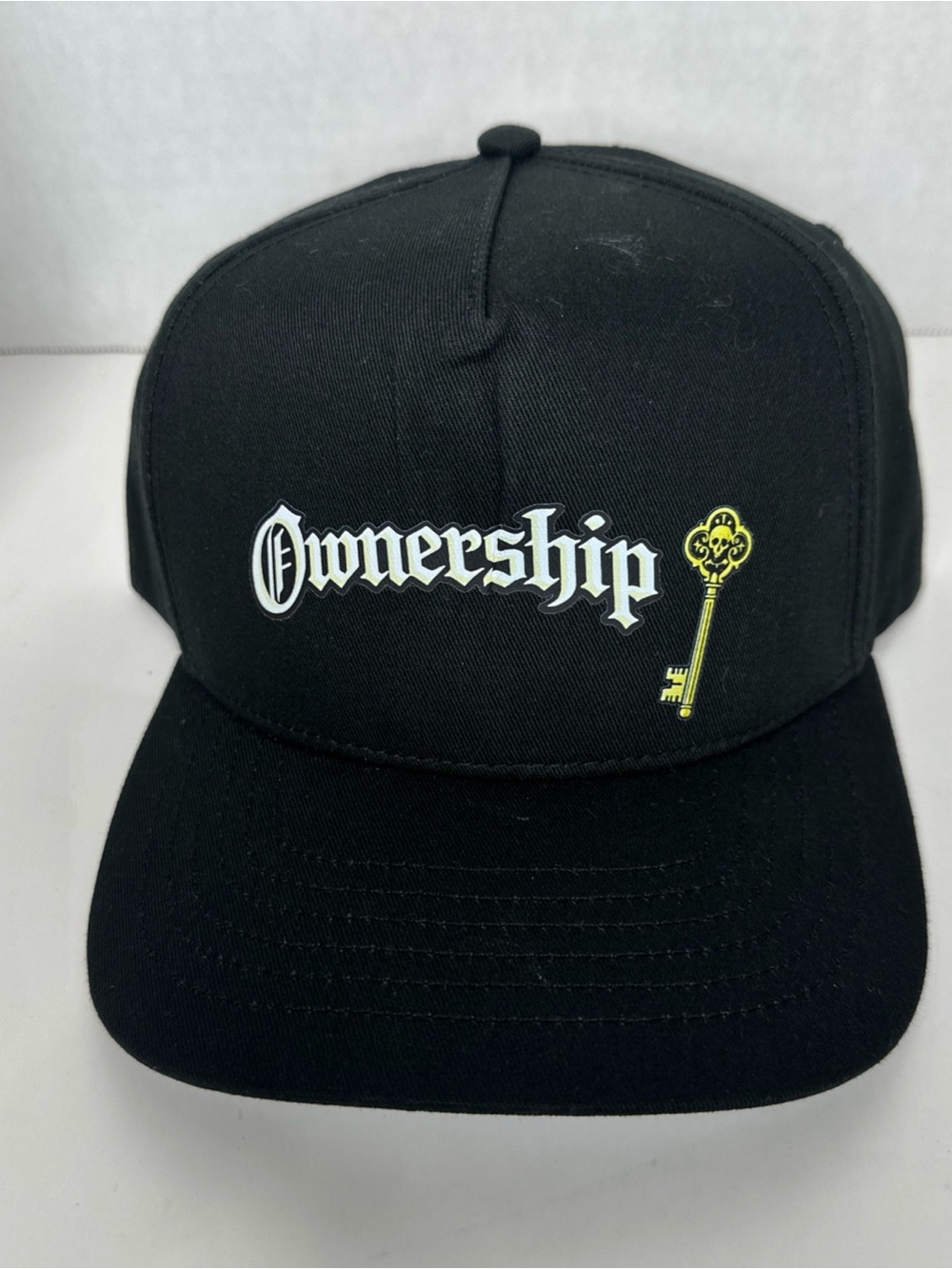 Ownership Logo Black Snapback Hat with Gold Key Accent